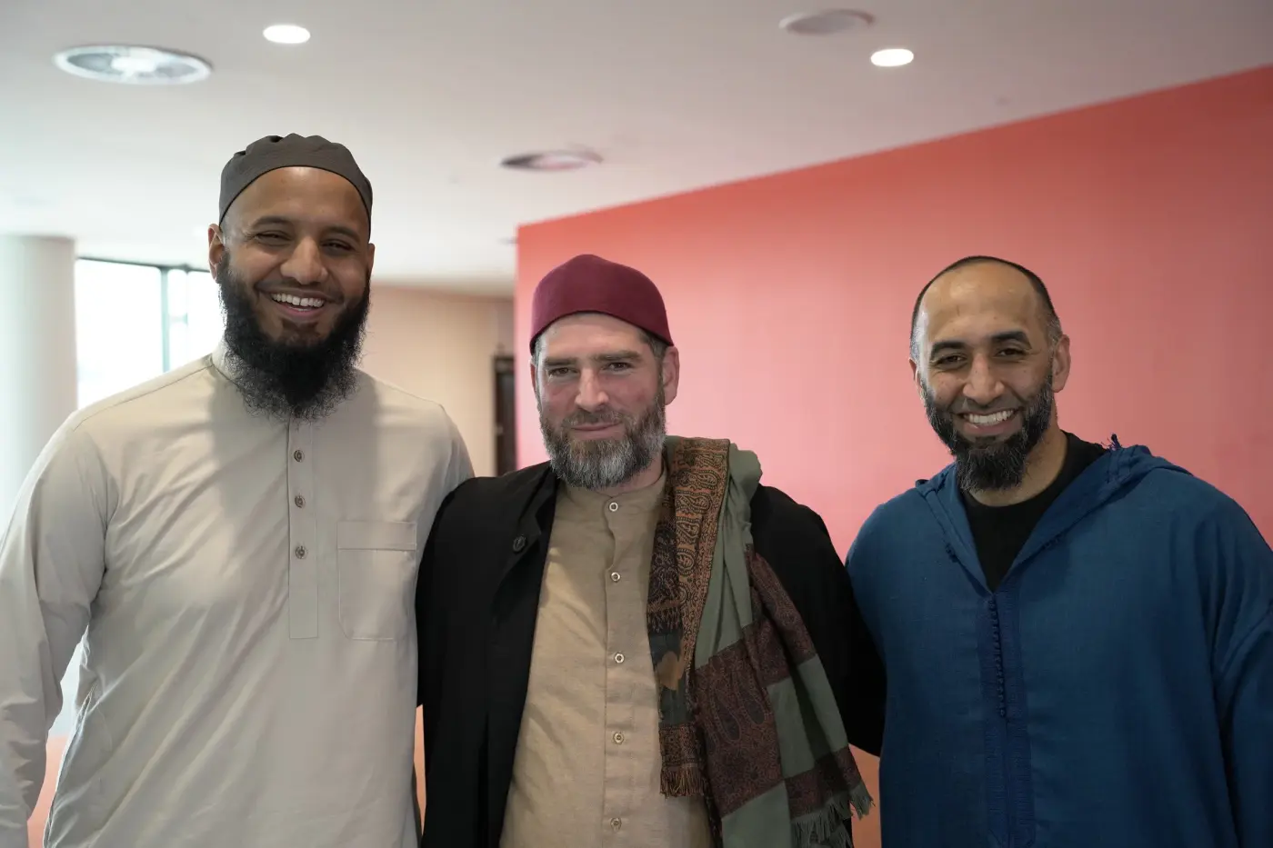 Three of the conference's speakers smiling together in the lobby